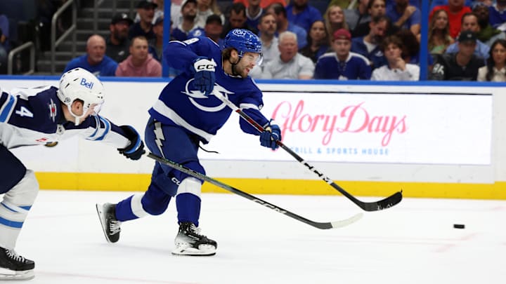 Nov 14, 2024; Tampa, Florida, USA; Tampa Bay Lightning left wing Brandon Hagel (38) shoots as Winnipeg Jets defenseman Neal Pionk (4) defends during the first period at Amalie Arena. Mandatory Credit: Kim Klement Neitzel-Imagn Images