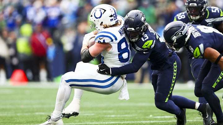 Dec 14, 2025; Seattle, Washington, USA; Seattle Seahawks linebacker Ernest Jones IV (13) tackles Indianapolis Colts tight end Tyler Warren (84) following a reception by Warren during the second quarter at Lumen Field. Mandatory Credit: Kevin Ng-Imagn Images