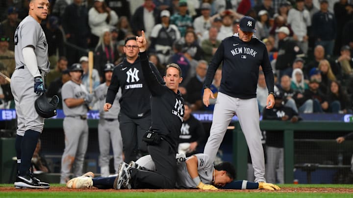 Seattle, Washington, USA; Trainers tend to New York Yankees third baseman Oswaldo Cabrera (95) after getting injured while scoring a run against the Seattle Mariners during the ninth inning at T-Mobile Park. Seattle, Washington, USA; Trainers tend to New York Yankees third baseman Oswaldo Cabrera (95) after getting injured while scoring a run against the Seattle Mariners during the ninth inning at T-Mobile Park.