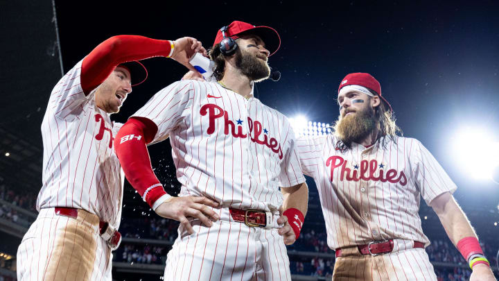 May 21, 2024; Philadelphia, Pennsylvania, USA; Philadelphia Phillies first base Bryce Harper (3) celebrates with Bryson Stott (L) and Brandon Marsh (R) after a victory against the Texas Rangers at Citizens Bank Park. 