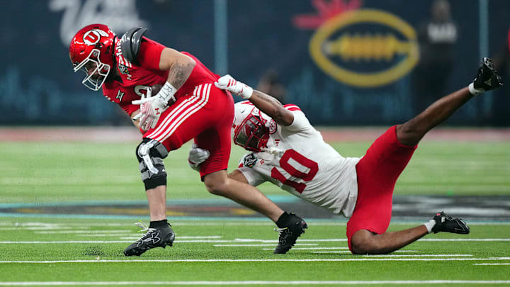 Utah wide receiver Ryan Davis carries the ball against Nebraska defensive back Andrew Marshall. Utah wide receiver Ryan Davis carries the ball against Nebraska defensive back Andrew Marshall.