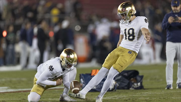 Nov 29, 2025; Stanford, California, USA;  Notre Dame Fighting Irish kicker Erik Schmidt (18) warms up with Notre Dame Fighting Irish quarterback Tyler Buchner (10) before the start of the first quarter against the Stanford Cardinal at Stanford Stadium. 