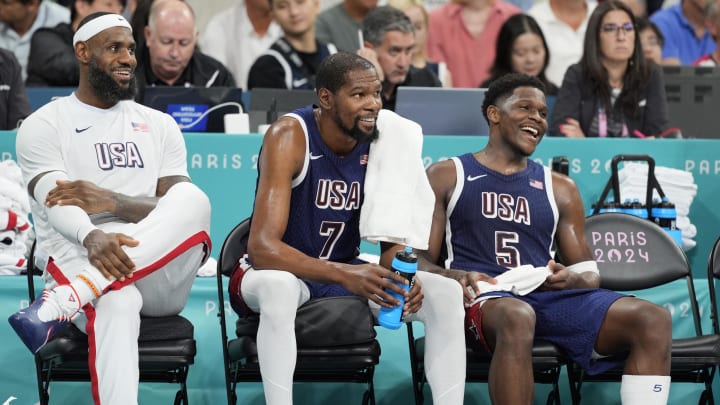 Aug 3, 2024; Villeneuve-d'Ascq, France; United States guard LeBron James (6), guard Kevin Durant (7) and guard Anthony Edwards (5) on the bench in the fourth quarter against Puerto Rico during the Paris 2024 Olympic Summer Games at Stade Pierre-Mauroy. Mandatory Credit: John David Mercer-USA TODAY Sports