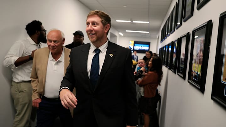 Liam Coen, center, walks with his father Tim Coen, left, as Edna Garcia, mother-in-law, right, holds son Callahan Coen, 7 months, after speaking and being introduced as the new Jacksonville Jaguars head coach during a press conference Monday, Jan. 27, 2025 at the Miller Electric Center in Jacksonville, Fla.