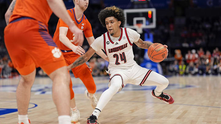 Mar 14, 2025; Charlotte, NC, USA; Louisville Cardinals guard Chucky Hepburn (24) handles the ball against Clemson Tigers guard Jake Heidbreder (3) during the second half at Spectrum Center. Mandatory Credit: Jim Dedmon-Imagn Images