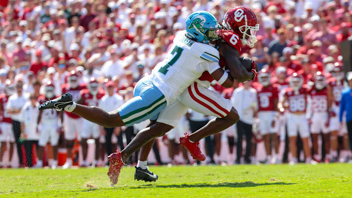 Sep 14, 2024; Norman, Oklahoma, USA; Oklahoma Sooners wide receiver Deion Burks (6) runs with the ball as Tulane Green Wave safety Caleb Ransaw (7) defends during the first half at Gaylord Family-Oklahoma Memorial Stadium. Sep 14, 2024; Norman, Oklahoma, USA; Oklahoma Sooners wide receiver Deion Burks (6) runs with the ball as Tulane Green Wave safety Caleb Ransaw (7) defends during the first half at Gaylord Family-Oklahoma Memorial Stadium.