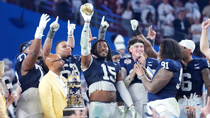 The Penn State Nittany Lions react with the trophy after defeating the Boise State Broncos in the Fiesta Bowl at State Farm Stadium. The Penn State Nittany Lions react with the trophy after defeating the Boise State Broncos in the Fiesta Bowl at State Farm Stadium.