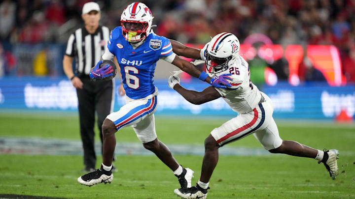 Jan 2, 2026; San Diego, CA, USA; SMU Mustangs running back Chris Johnson Jr. (6) carries the ball against Arizona Wildcats defensive back Coleman Patmon (26) in the first half during the Holiday Bowl at Snapdragon Stadium. Mandatory Credit: Kirby Lee-Imagn Images Jan 2, 2026; San Diego, CA, USA; SMU Mustangs running back Chris Johnson Jr. (6) carries the ball against Arizona Wildcats defensive back Coleman Patmon (26) in the first half during the Holiday Bowl at Snapdragon Stadium. Mandatory Credit: Kirby Lee-Imagn Images