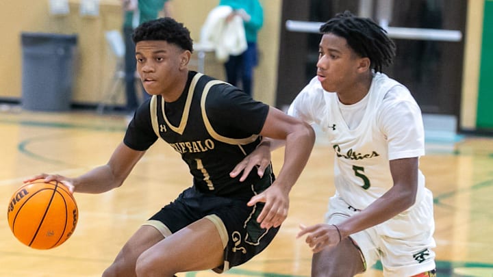 Villiages Charter guard Adyn Corbin (1) drives against Trinity Catholic guard Brandon Haughton (5) during a high school basketball game at Trinity Catholic High School in Ocala, FL on Tuesday, January 16, 2024.