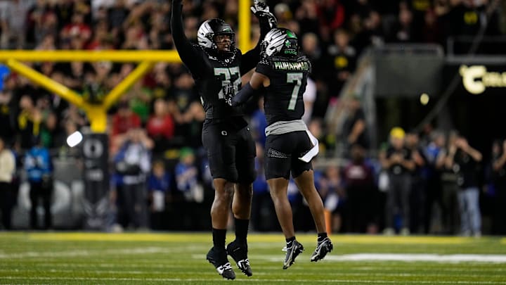 Oregon linebacker Emar'rion Winston (32) and defensive back Jabbar Muhammad celebrate after stopping Ohio State during their game at Autzen Stadium.