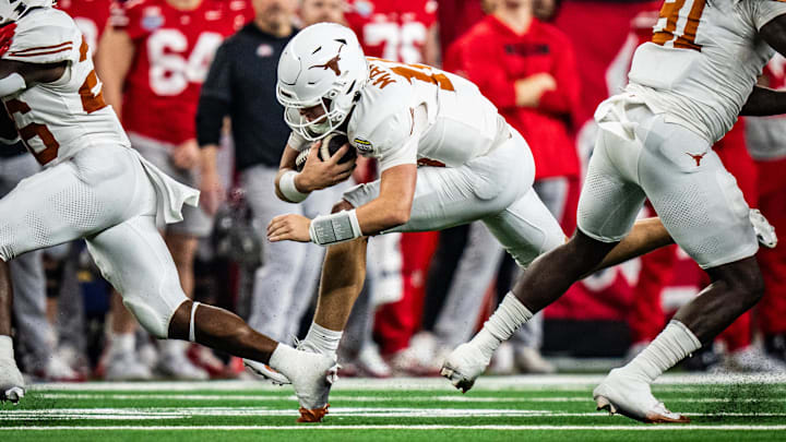 Jan 10, 2025; Arlington, TX, USA; Texas Longhorns quarterback Arch Manning (16) carries the ball for a first down in the second quarter as the Texas Longhorns play the Ohio State Buckeyes in the Cotton Bowl College Football Playoff semi-final at AT&T Stadium in Dallas, Texas. Mandatory Credit: Sara Diggins/USA TODAY Network via Imagn Images