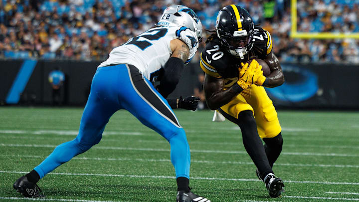  Aug 21, 2025; Charlotte, North Carolina, USA;  Pittsburgh Steelers running back Kaleb Johnson (20) runs the ball as Carolina Panthers safety Lathan Ransom (22) attempts to block him during the 2nd quarter at Bank of America Stadium. Mandatory Credit: Allison Lawhon-Imagn Images