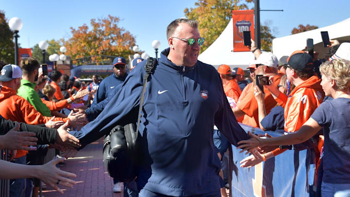 Oct 19, 2024; Champaign, Illinois, USA; Illinois Fighting Illini head coach Bret Bielema leads his team into the stadium before kickoff against the Michigan Wolverines game at Memorial Stadium. Mandatory Credit: Ron Johnson-Imagn Images