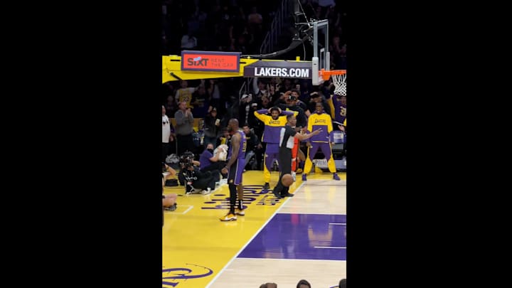 Lakers guard Bronny James reacts to an alley-oop dunk from LeBron against the Washington Wizards.