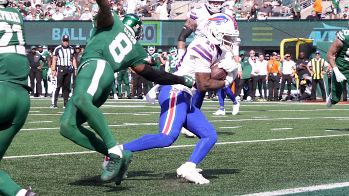 Sep 14, 2025; East Rutherford, New Jersey, USA; Buffalo Bills wide receiver Elijah Moore (18) avoids the tackle of New York Jets safety Andre Cisco (8) to score a touchdown