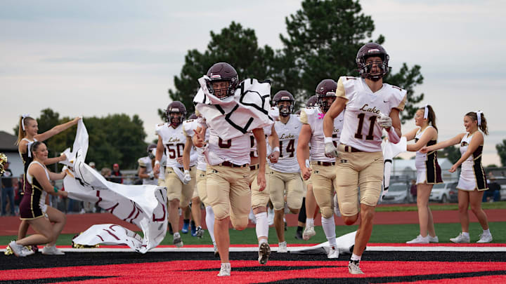 Silver Lake players run onto the field during the War on 24 football game at Rossville High School, Friday, Sept. 5, 2025.