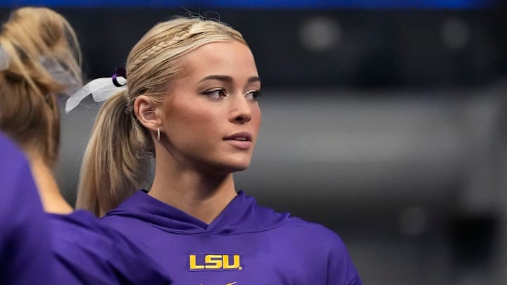 Mar 22, 2025; Birmingham AL, USA; LSU gymnast Livvy Dunne stretches with teammates before Session 2 of the SEC Gymnastics Tournament at Legacy Arena in Birmingham, Alabama.