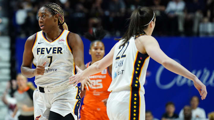 Jun 10, 2024; Uncasville, Connecticut, USA; Indiana Fever forward Aliyah Boston (7) and guard Caitlin Clark (22) react after a basket against the Connecticut Sun in the first quarter at Mohegan Sun Arena. Mandatory Credit: David Butler II-Imagn Images