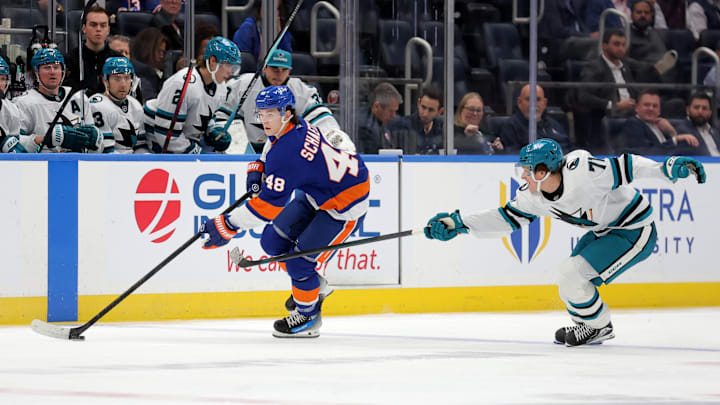 Oct 21, 2025; Elmont, New York, USA; New York Islanders defenseman Matthew Schaefer (48) skates with the puck against San Jose Sharks center Macklin Celebrini (71) during the second period at UBS Arena. Mandatory Credit: Brad Penner-Imagn Images