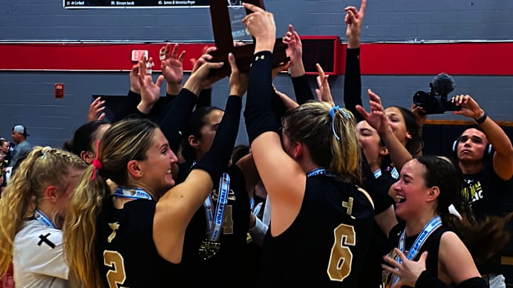 Orlando Bishop Moore players celebrate after winning the Class 4A girls volleyball state championship game on Saturday at Polk State College in Winter Haven.