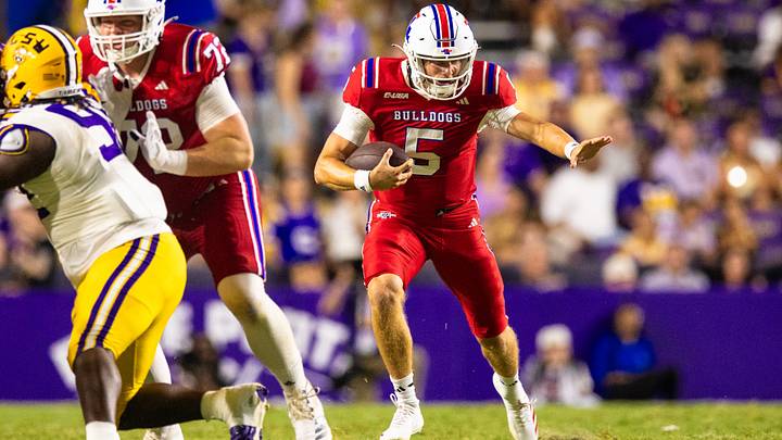Sep 6, 2025; Baton Rouge, Louisiana, USA;  Louisiana Tech Bulldogs quarterback Blake Baker (5) scrambles out the pocket against LSU Tigers during the second half  at Tiger Stadium. Mandatory Credit: Stephen Lew-Imagn Images