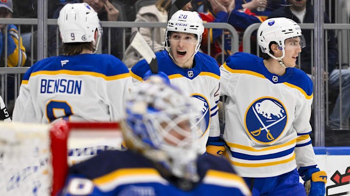 Dec 29, 2024; St. Louis, Missouri, USA;  Buffalo Sabres center Jiri Kulich (20) is congratulated by defenseman Dennis Gilbert (8) and center Peyton Krebs (19) after scoring against St. Louis Blues goaltender Jordan Binnington (50) during the third period at Enterprise Center. Mandatory Credit: Jeff Curry-Imagn Images