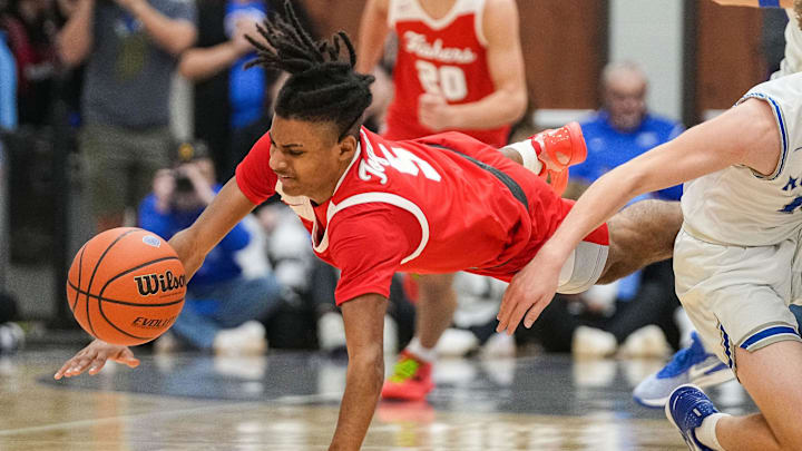 Fishers Tigers guard Jason Gardner Jr. (5) reaches for the ball against Hamilton Southeastern Royals Braeden Totton (13) on Friday, Dec. 15, 2023, during the game at Hamilton Southeastern High School in Fishers. The Fishers Tigers defeated the Hamilton Southeastern Royals, 64-57. Fishers Tigers guard Jason Gardner Jr. (5) reaches for the ball against Hamilton Southeastern Royals Braeden Totton (13) on Friday, Dec. 15, 2023, during the game at Hamilton Southeastern High School in Fishers. The Fishers Tigers defeated the Hamilton Southeastern Royals, 64-57.