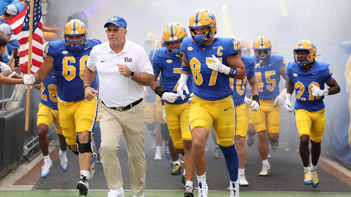 Sep 27, 2025; Pittsburgh, Pennsylvania, USA;  Pittsburgh Panthers head coach Pat Narduzzi (white) and tight end Jake Overman (87) lead the team onto the field to play the Louisville Cardinals at Acrisure Stadium. Mandatory Credit: Charles LeClaire-Imagn Images