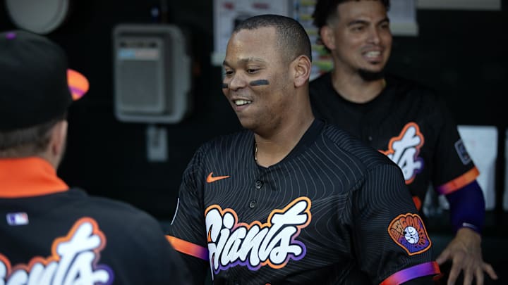 San Francisco Giants designated hitter Rafael Devers greets his new teammates in the dugout before taking on the Cleveland Guardians.