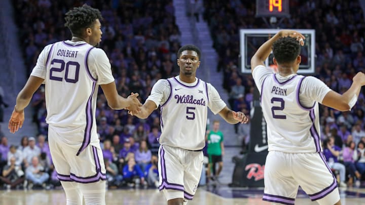 Feb 5, 2024; Manhattan, Kansas, USA; Kansas State Wildcats guard Cam Carter (5) is congratulated by teammates versus No. 4 Kansas.