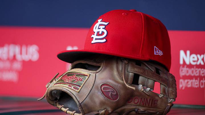Apr 21, 2025; Atlanta, Georgia, USA; A St. Louis Cardinals hat and glove in the dugout against the Atlanta Braves in the first inning at Truist Park. Mandatory Credit: Brett Davis-Imagn Images