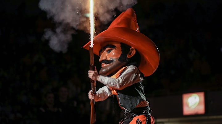 Pistol Pete fires a shotgun before a college wrestling meet between the Oklahoma State Cowboys (OSU) and the Oklahoma Sooners at Gallagher-Iba Arena in Stillwater, Okla., Thursday, Feb. 16, 2023.

Osu Vs Ou