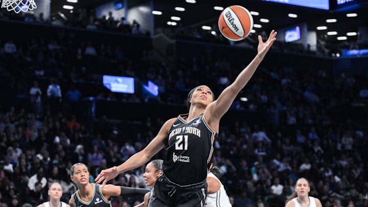 May 29, 2025; Brooklyn, New York, USA; New York Liberty forward Isabelle Harrison (21) grabs a rebound against the Golden State Valkyries during the first half at Barclays Center. Mandatory Credit: John Jones-Imagn Images