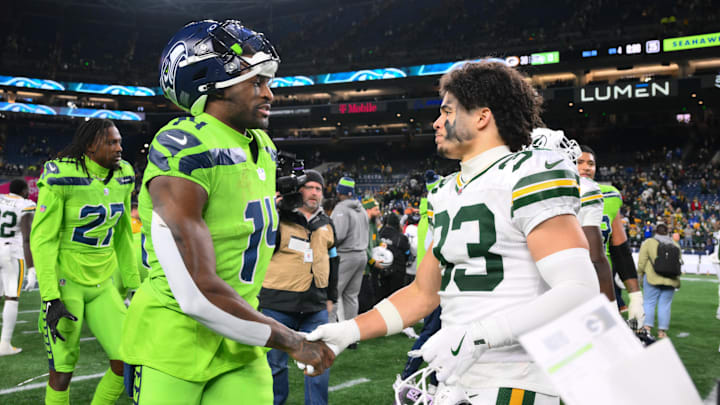 Dec 15, 2024; Seattle, Washington, USA; Seattle Seahawks wide receiver DK Metcalf (14) and Green Bay Packers safety Evan Williams (33) shake hands after the game at Lumen Field. Mandatory Credit: Steven Bisig-Imagn Images
