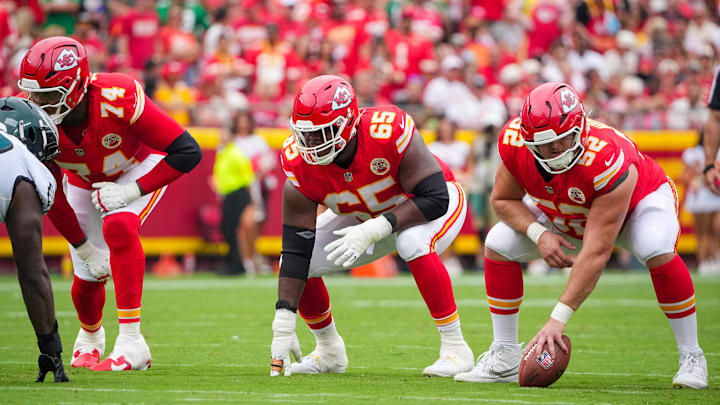 Sep 14, 2025; Kansas City, Missouri, USA; Kansas City Chiefs offensive tackle Jawaan Taylor (74) and guard Trey Smith (65) and center Creed Humphrey (52) at the line of scrimmage against the Philadelphia Eagles during the game at GEHA Field at Arrowhead Stadium. Mandatory Credit: Denny Medley-Imagn Images