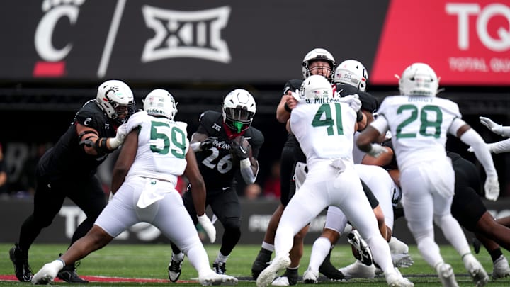 Cincinnati Bearcats running back Myles Montgomery (26) carries the ball as the offensive line blocks in the first quarter during a college football game between the Baylor Bears and the Cincinnati Bearcats, Saturday, Oct. 21, 2023, at Nippert Stadium in Cincinnati. Cincinnati Bearcats running back Myles Montgomery (26) carries the ball as the offensive line blocks in the first quarter during a college football game between the Baylor Bears and the Cincinnati Bearcats, Saturday, Oct. 21, 2023, at Nippert Stadium in Cincinnati.