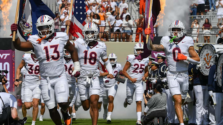 Sep 20, 2025; Blacksburg, Va.; Virginia Tech defensive lineman Kemari Copeland (13), quarterback A.J. Brand (18) and wide receiver Ayden Greene (0) run onto the field. Sep 20, 2025; Blacksburg, Va.; Virginia Tech defensive lineman Kemari Copeland (13), quarterback A.J. Brand (18) and wide receiver Ayden Greene (0) run onto the field.
