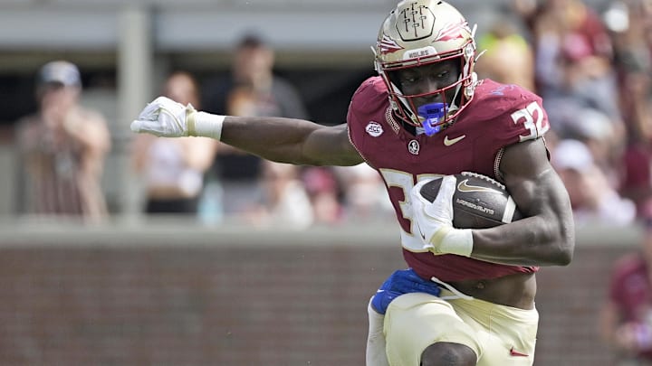 Oct 11, 2025; Tallahassee, Florida, USA; Florida State Seminoles running back Ousmane Kromah (32) is tackled by Pittsburgh Panthers linebacker Braylan Lovelace (0) during the second half at Doak S. Campbell Stadium. Mandatory Credit: Melina Myers-Imagn Images