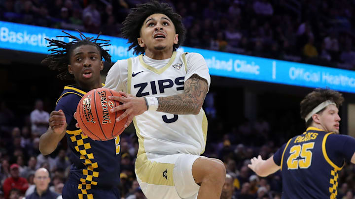 Akron Zips guard Sharron Young (3) looks for a layup ahead of Toledo Rockets guard Leroy Blyden Jr. (2) and center Austin Parks (25) during the second half of the Mid-American Conference championship at Rocket Arena, March 14, 2026, in Cleveland, Ohio. Akron Zips guard Sharron Young (3) looks for a layup ahead of Toledo Rockets guard Leroy Blyden Jr. (2) and center Austin Parks (25) during the second half of the Mid-American Conference championship at Rocket Arena, March 14, 2026, in Cleveland, Ohio.