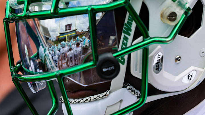 Oct 28, 2023; Houston, Texas, USA; The facemark of Tulane Green Wave defensive back Rayshawn Pleasant (25) reflects his teammates as he warms up before a game against the Rice Owls. 