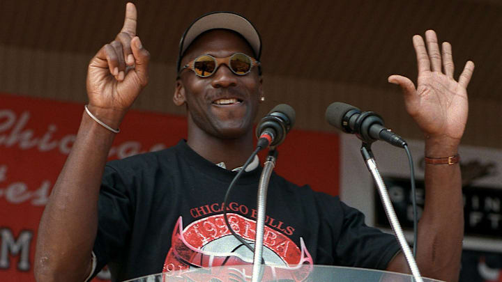 Michael Jordan holds up six fingers for each Bulls championship as he addresses the crowd at the Petrillo Music Shell at Grant Park.