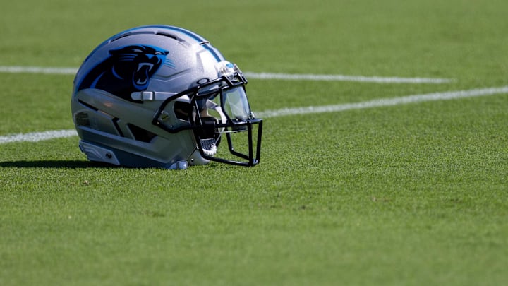 Jul 23, 2025; Charlotte, NC, USA; A Carolina Panthers helmet sits on the ground at training camp. Mandatory Credit: Scott Kinser-Imagn Images
