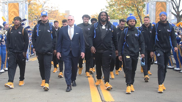 Oct 25, 2025; Pittsburgh, Pennsylvania, USA; Pittsburgh Panthers head coach Pat Narduzzi (middle) leads the Panthers to the stadium to play the North Carolina State Wolfpack at Acrisure Stadium. Mandatory Credit: Charles LeClaire-Imagn Images