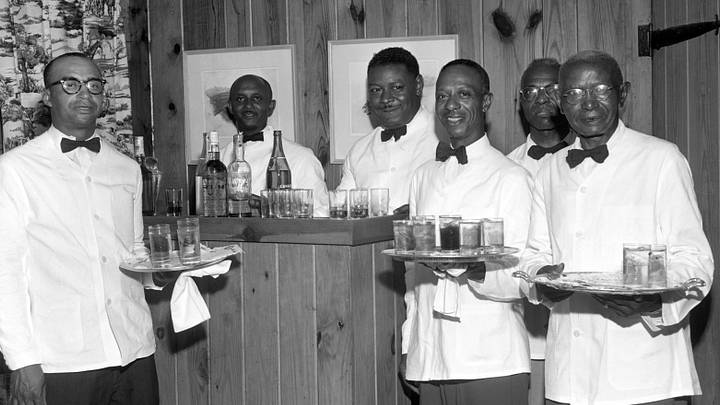 A group of African American waiters stop to smile on their way to deliver cocktails circa 1950 Nashville, Tennessee. A group of African American waiters stop to smile on their way to deliver cocktails circa 1950 Nashville, Tennessee.