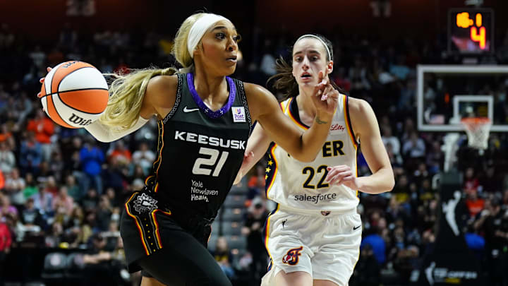 May 14, 2024; Uncasville, Connecticut, USA; Connecticut Sun guard DiJonai Carrington (21) drives the ball against Indiana Fever guard Caitlin Clark (22) in the second half at Mohegan Sun Arena. Mandatory Credit: David Butler II-Imagn Images May 14, 2024; Uncasville, Connecticut, USA; Connecticut Sun guard DiJonai Carrington (21) drives the ball against Indiana Fever guard Caitlin Clark (22) in the second half at Mohegan Sun Arena. Mandatory Credit: David Butler II-Imagn Images