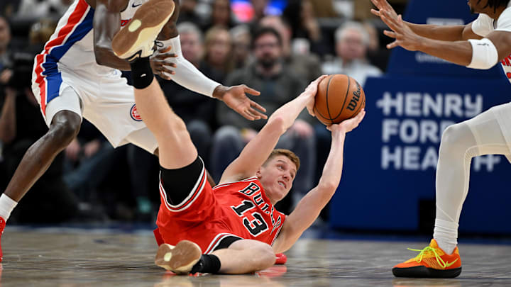 Jan 7, 2026; Detroit, Michigan, USA; Chicago Bulls guard Kevin Huerter (13) looks to for a teammate to pass the ball to after beating Detroit Pistons forward Paul Reed (left) and Pistons guard Jaden Ivey (right) to a loose ball in the second quarter at Little Caesars Arena. Mandatory Credit: Lon Horwedel-Imagn Images