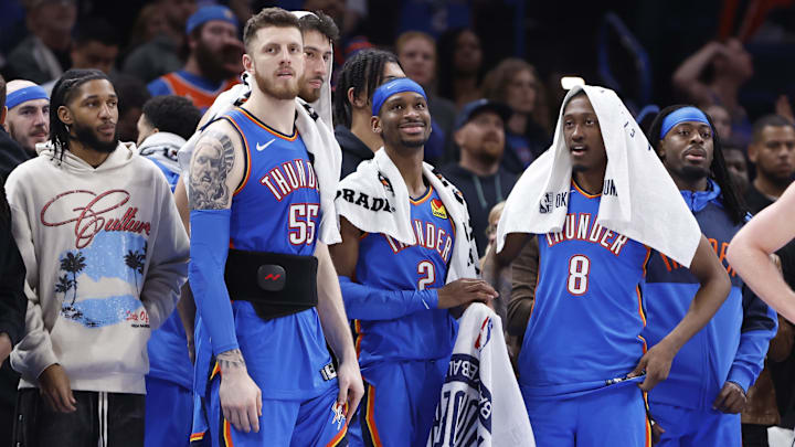 Feb 10, 2025; Oklahoma City, Oklahoma, USA; Oklahoma City Thunder guard Isaiah Joe (11), center Isaiah Hartenstein (55), forward Chet Holmgren (7), guard Shai Gilgeous-Alexander (2), forward Jalen Williams (8) and guard Luguentz Dort (5) watch the end of a game against the New Orleans Pelicans at Paycom Center. Mandatory Credit: Alonzo Adams-Imagn Images