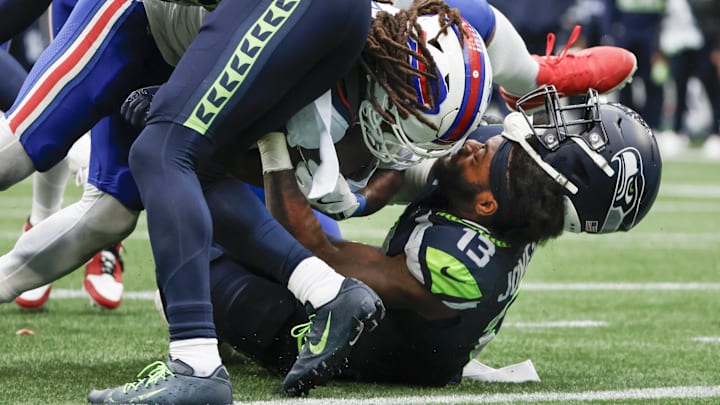 Oct 27, 2024; Seattle, Washington, USA; Buffalo Bills running back James Cook (4) rushes for a touchdown against Seattle Seahawks linebacker Ernest Jones IV (13) during the fourth quarter at Lumen Field.