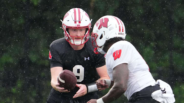Wisconsin quarterback Billy Edwards Jr. (9) gives a handoff to running back Darrion Dupree (6) during football practice, July 30, 2025, at Ralph E. Davis Pioneer Stadium in Platteville, Wisconsin.