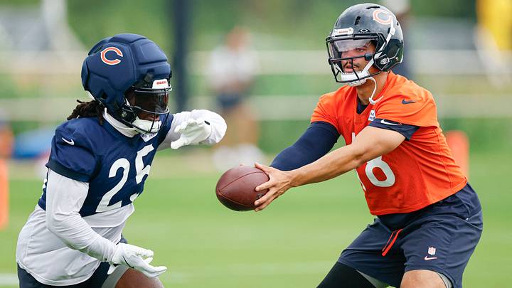Caleb Williams hands off to Kyle Monangai during running drills at Halas Hall in training camp. Caleb Williams hands off to Kyle Monangai during running drills at Halas Hall in training camp.